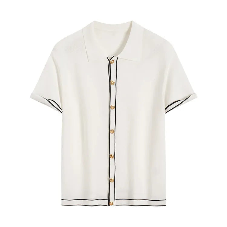 White short sleeve women's cardigan with dark contrasting lapels laid flat.