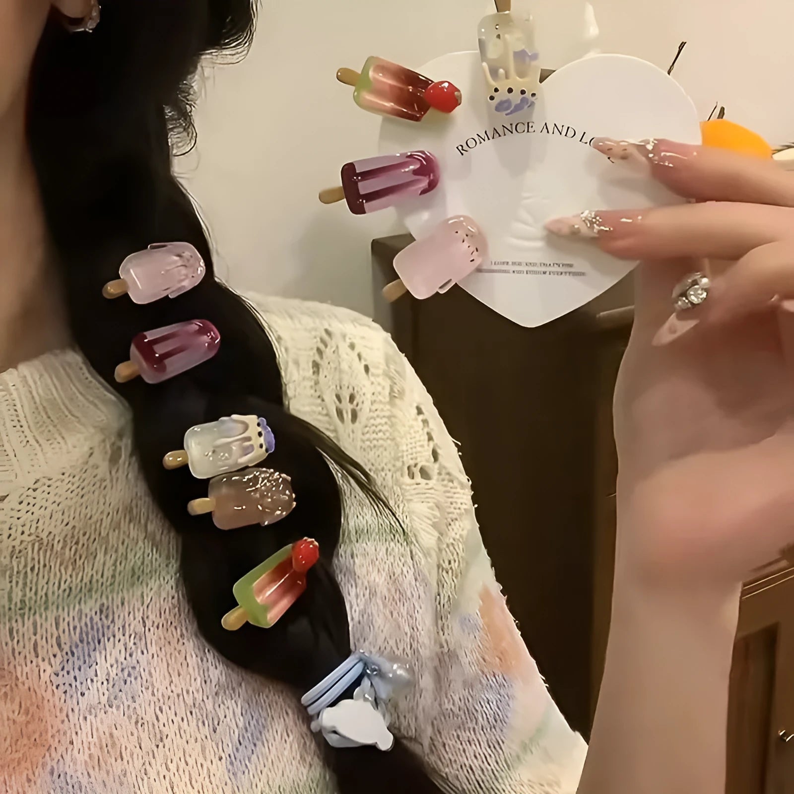 Close-up of a resin hair clip with a colourful cartoon ice cream design, shown in beige.