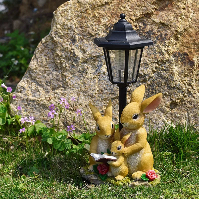 Hexagonal solar garden lamp with decorative resin animal design in outdoor setting