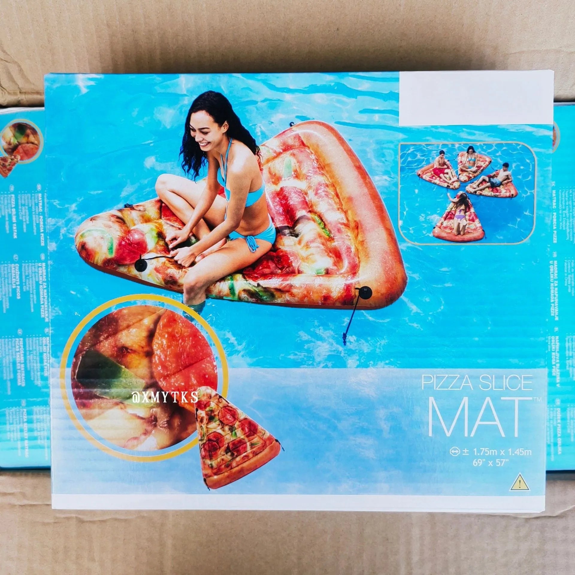 Large red and yellow inflatable pizza slice on a surfboard design, floating on water.