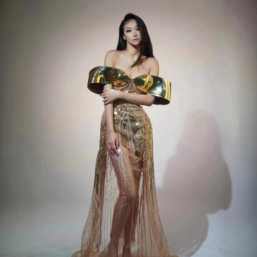Gold strapless sequin evening dress with high-low hemline and tulle skirt detailing.