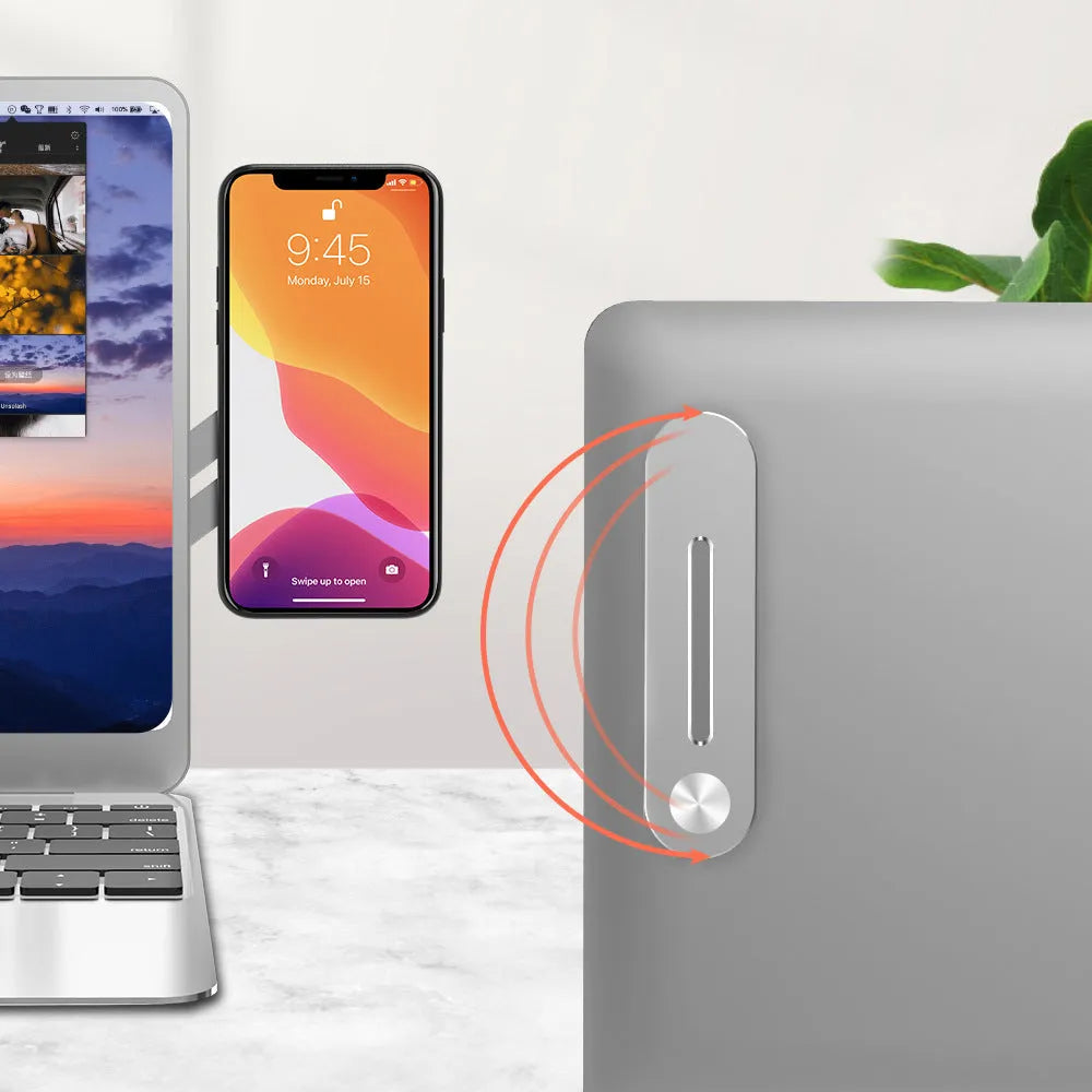 Silver aluminium laptop side mount bracket holding a mobile phone next to a laptop screen.