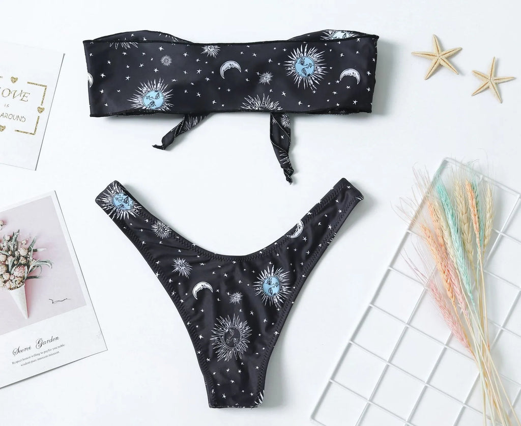 Black one-piece swimsuit with a bikini print pattern and a backless design.
