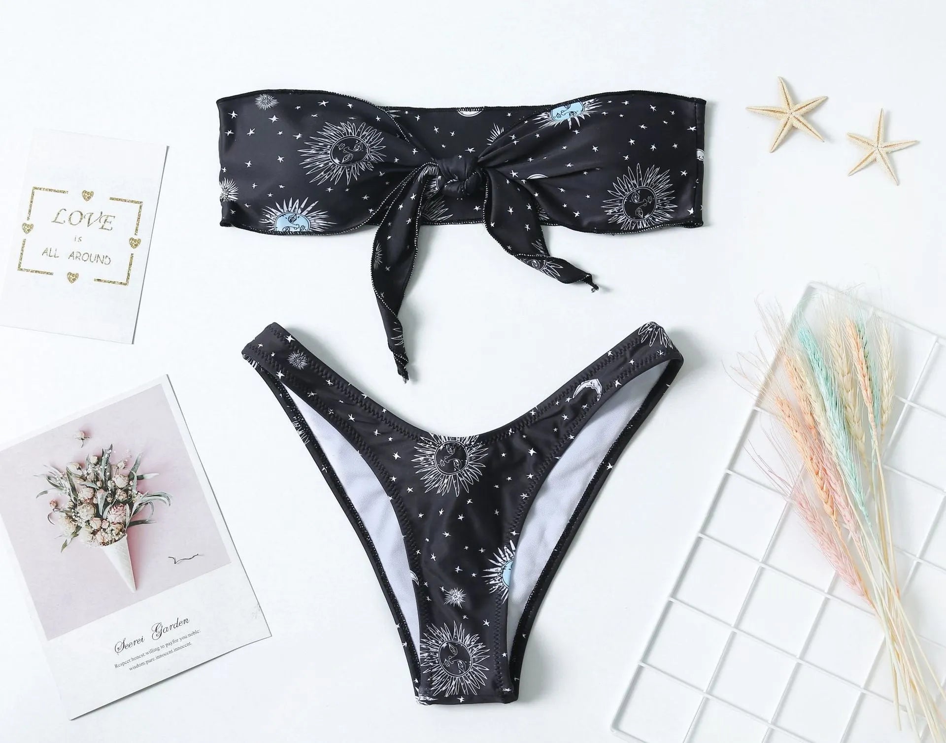Black one-piece swimsuit with a bikini print pattern and a backless design.
