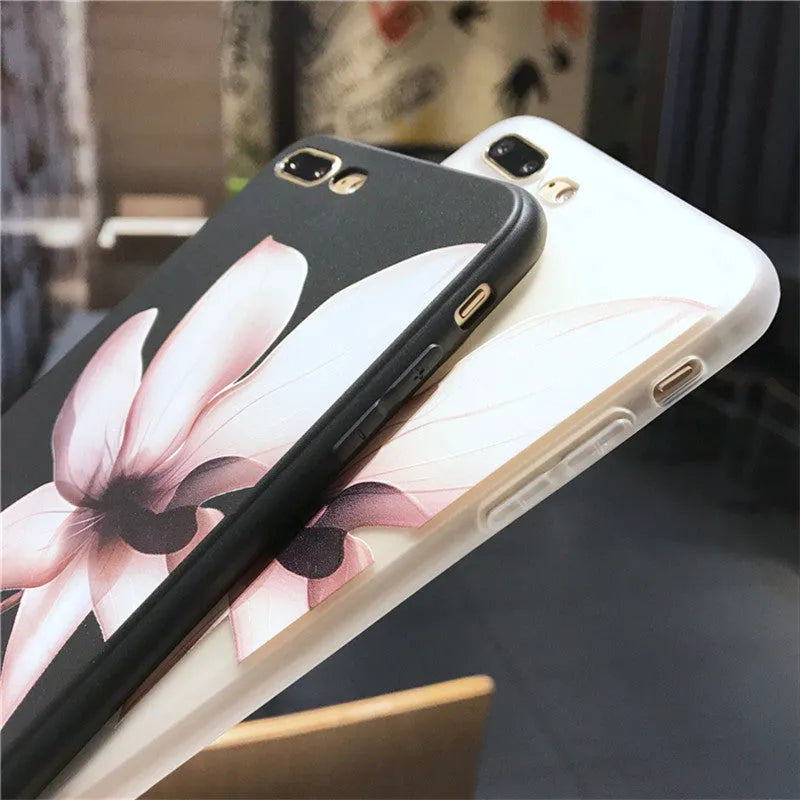Slim black iPhone case with a single raised embossed flower design on the back.