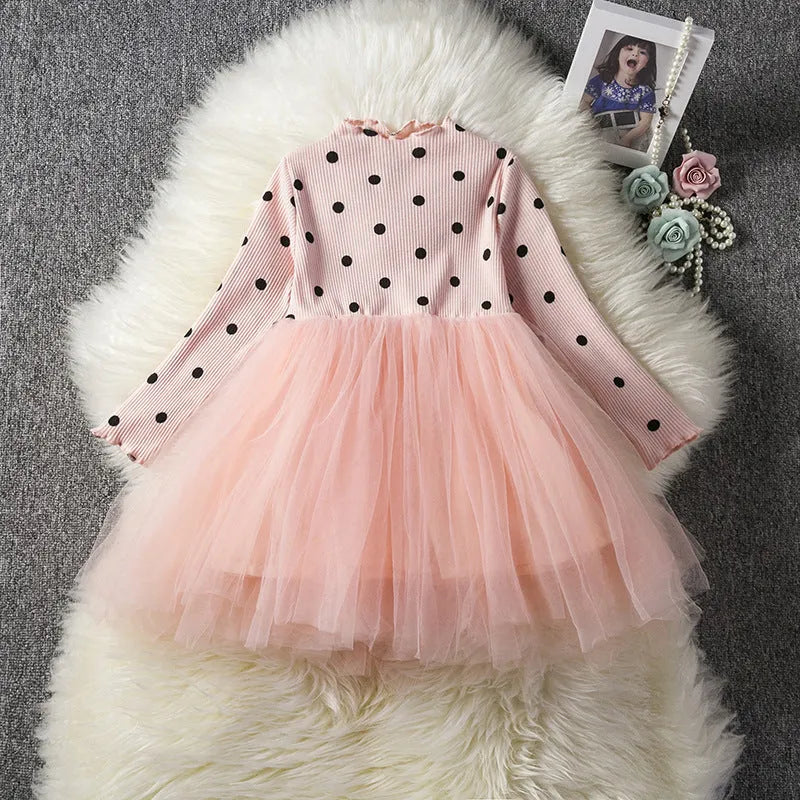 Baby girl in a long sleeve black tutu lace dress for a birthday party.