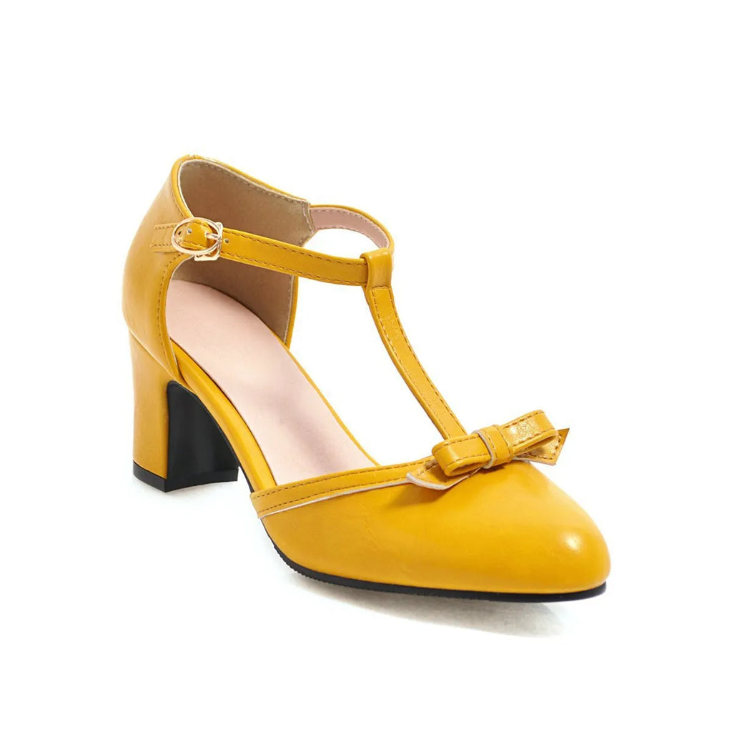 Women's apricot-colour sandals with a chunky heel, bow detail, and a hollow-out buckle strap on a round toe.