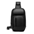 Black PVC outdoor shoulder bag with a square shape, showing the air cushion strap and front pocket.