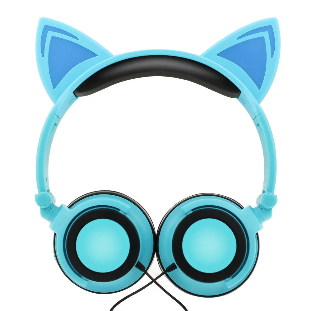 Colourful cat ear headphones with illuminated RGB LED lights in the ears and blue earcushions on a black background.