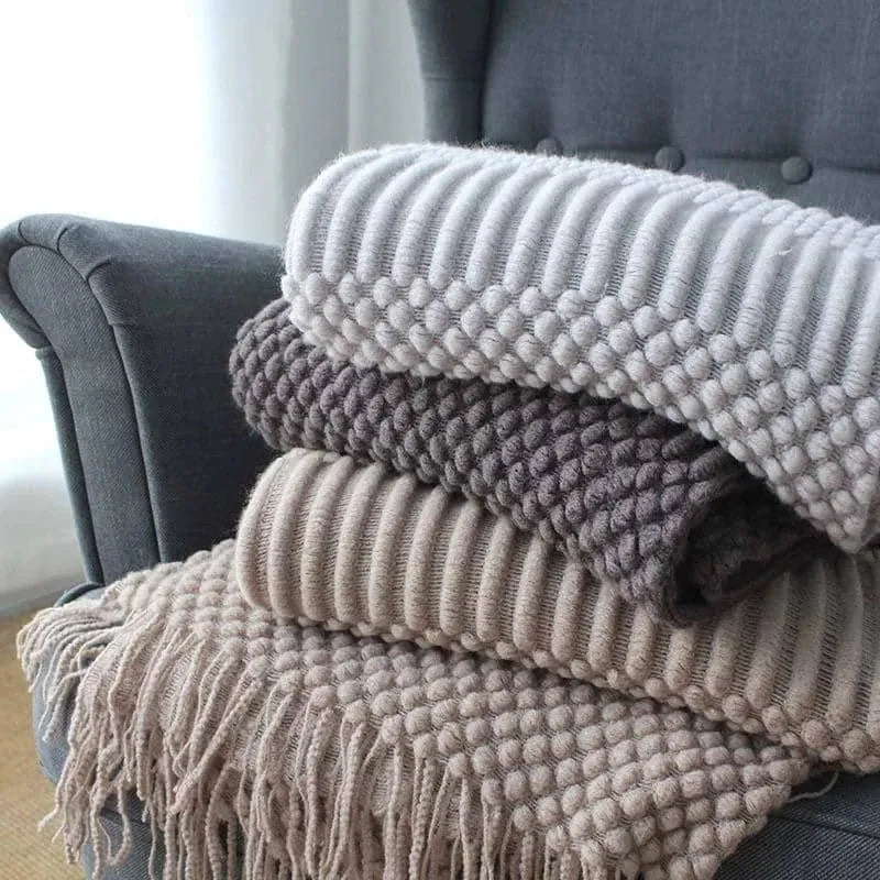Small light grey polyester blanket folded, showing its texture and 127x170cm size.