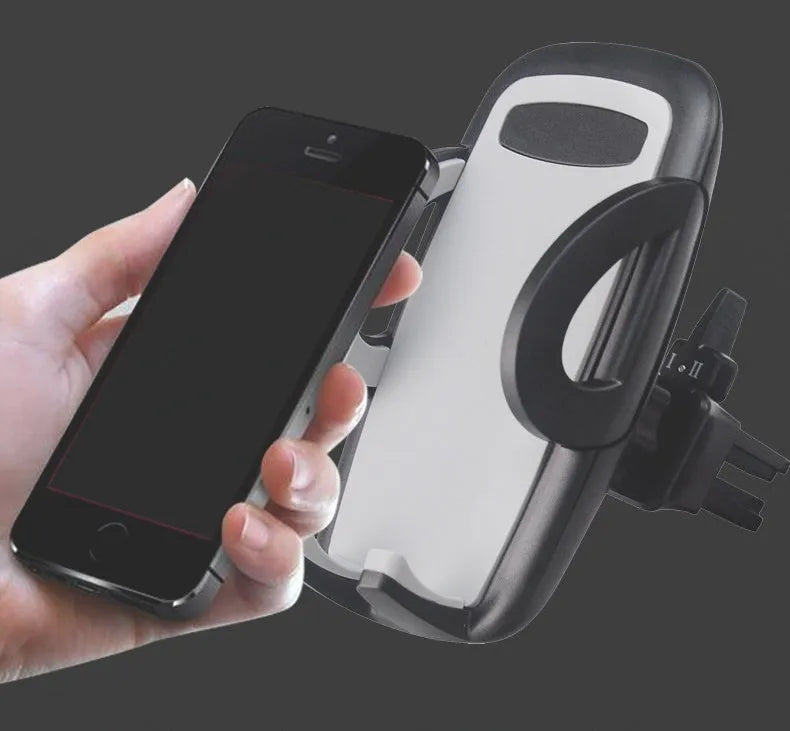 Black plastic mobile phone holder mounted on car air conditioning vent