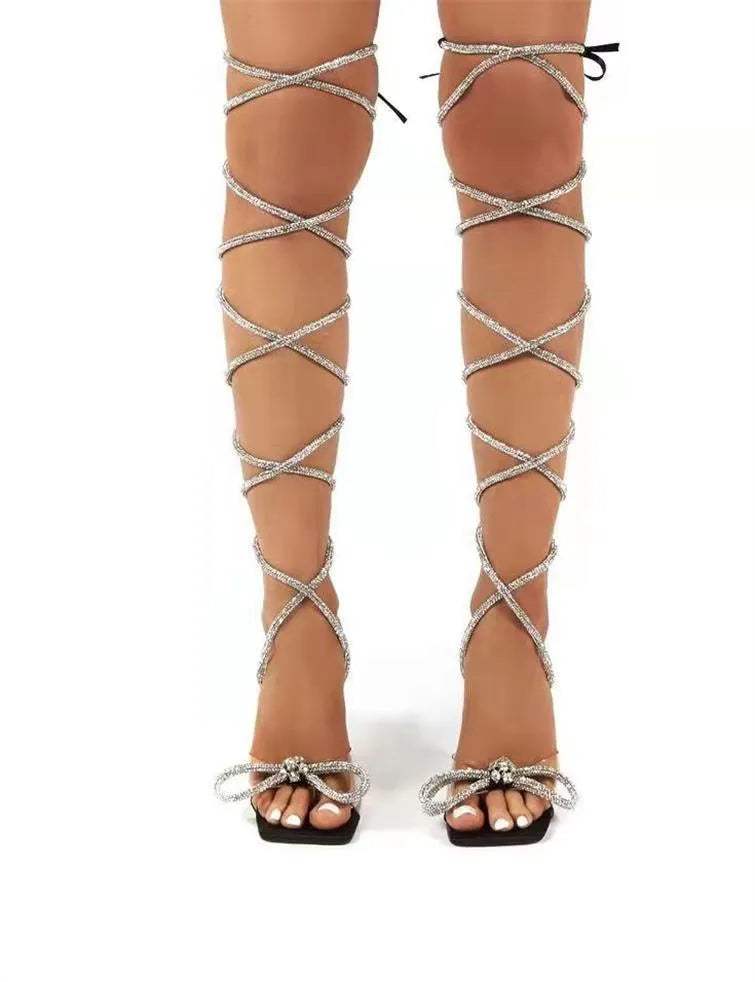 Plus size women's black strappy sandals with rhinestone decoration on the straps and a square toe.