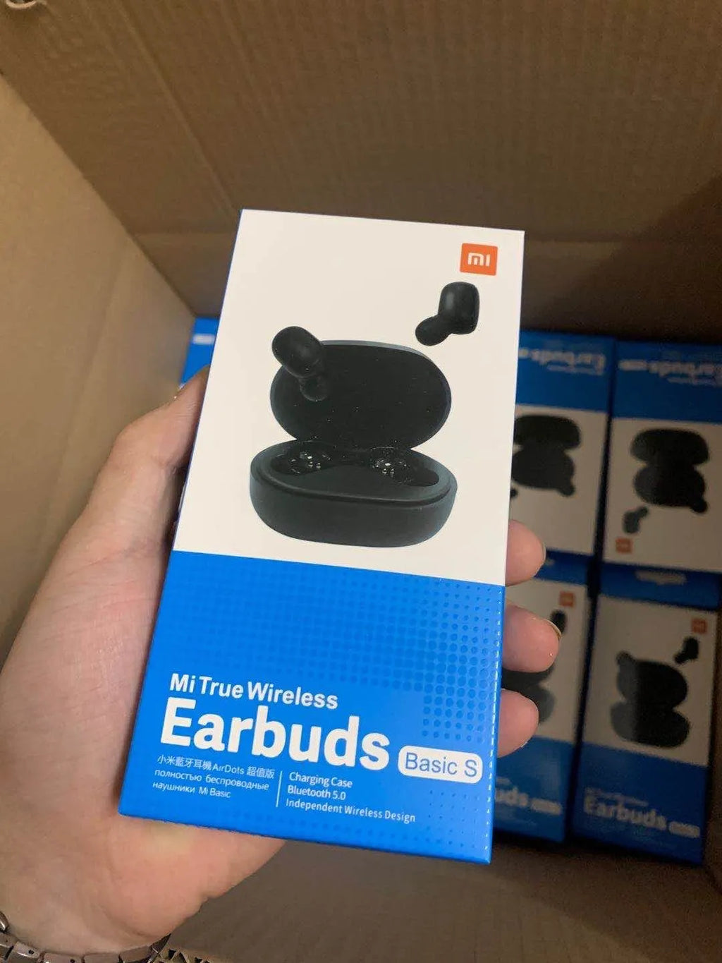 Black Redmi AirDots true wireless earbuds and charging case on a white background.