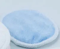 Velvet makeup remover pad in water pink and light blue colours showing bamboo polyester blend texture