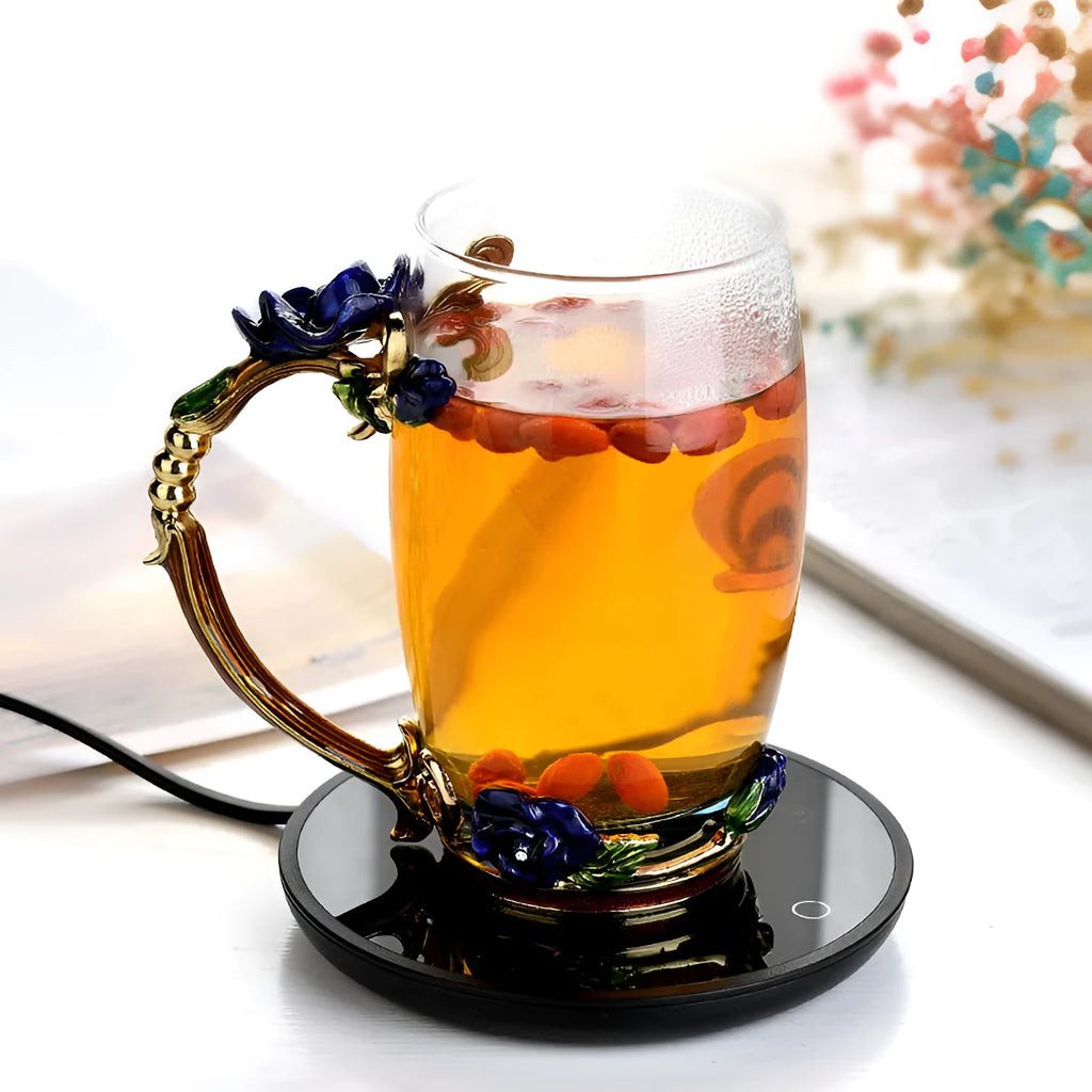 Black coffee mug warmer with temperature control dial on desk