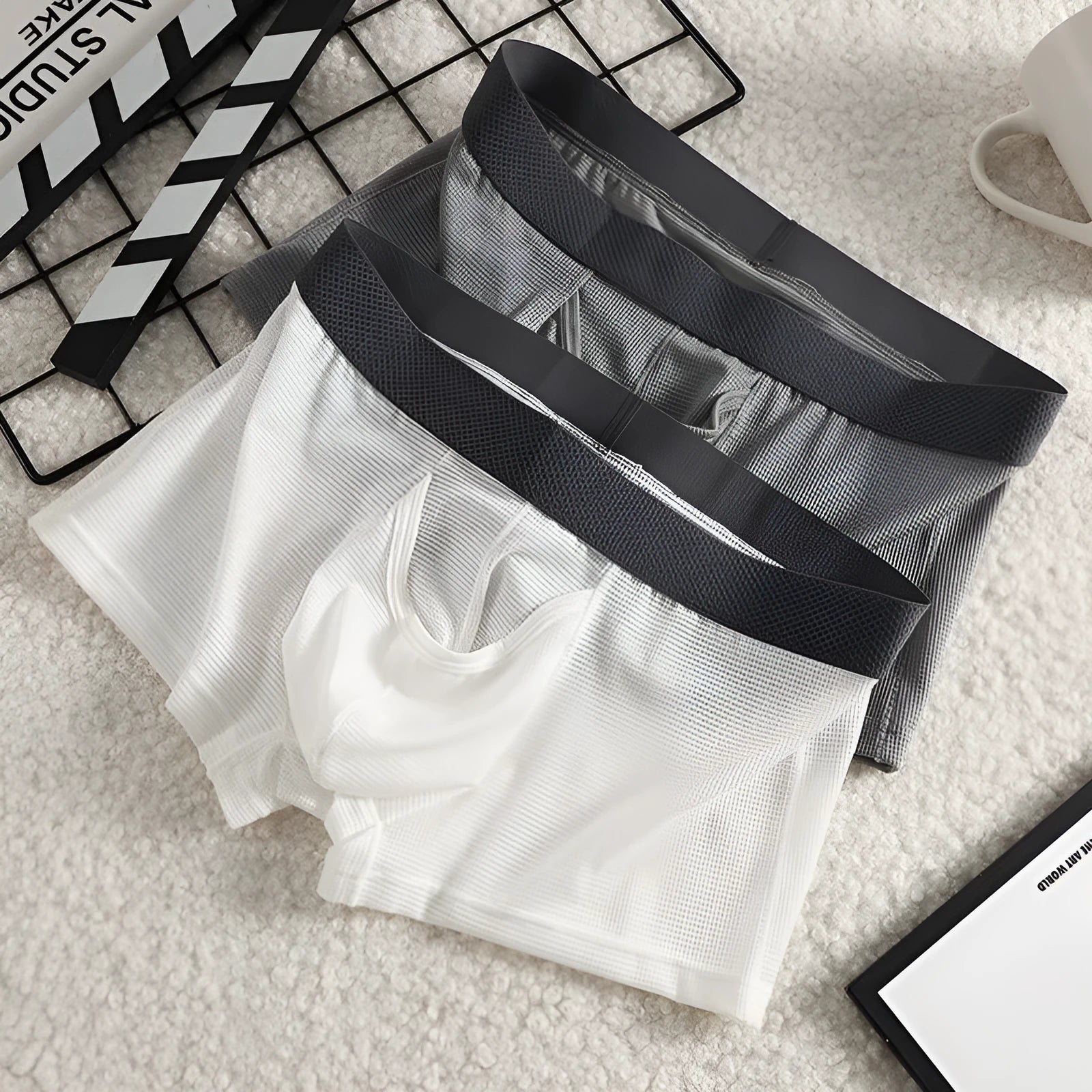 Men's solid colour ice silk boxer shorts showing low waist and breathable mesh fabric.
