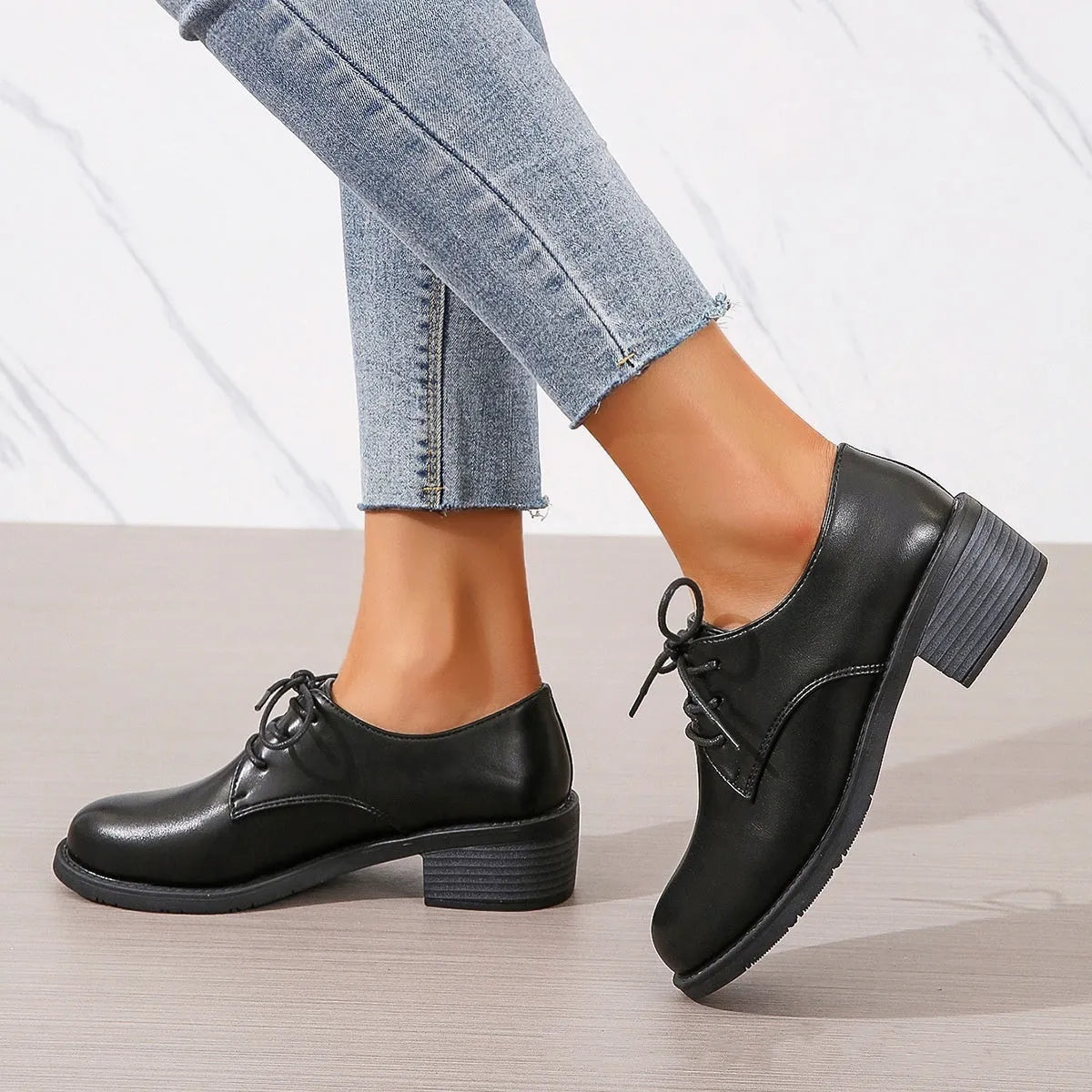 Black women's low-top PU leather shoes with a chunky mid-heel and pointed toe.