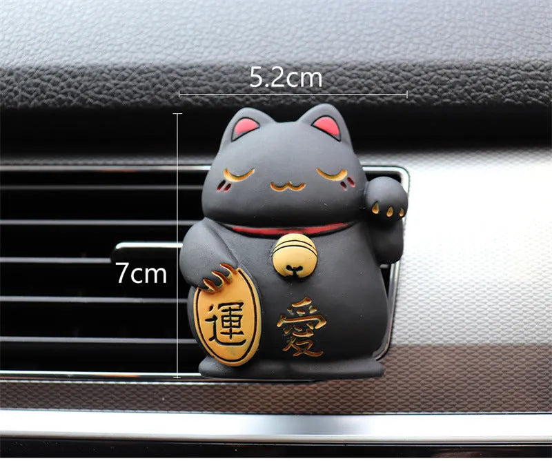 Black cat and white cat resin car vent clip aromatherapy diffuser on a car air conditioning vent.