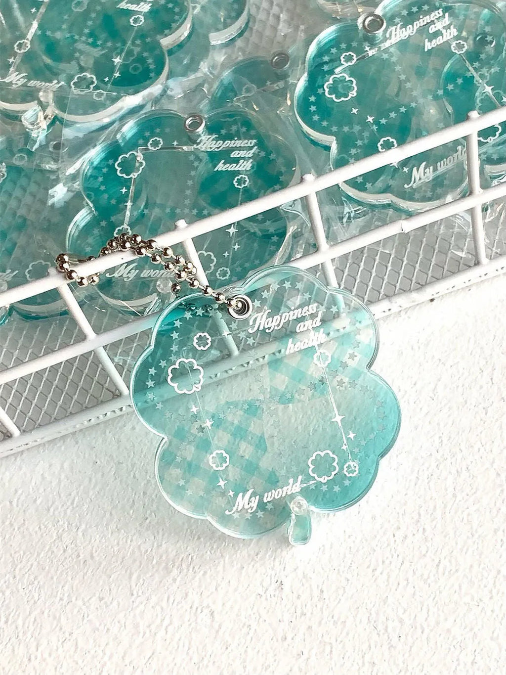 Lucky four-leaf clover shaped acrylic pendant keychain in blue, green, or mint green colours.