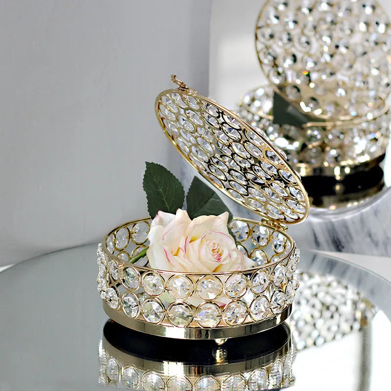 French gold metal jewelry box with a clear crystal glass front panel on display.