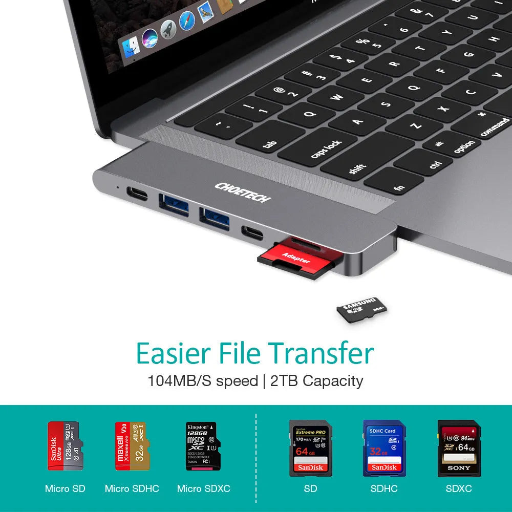 Silver aluminium USB-C hub adapter with SD card slot, HDMI, USB ports, and Thunderbolt 3 connector.