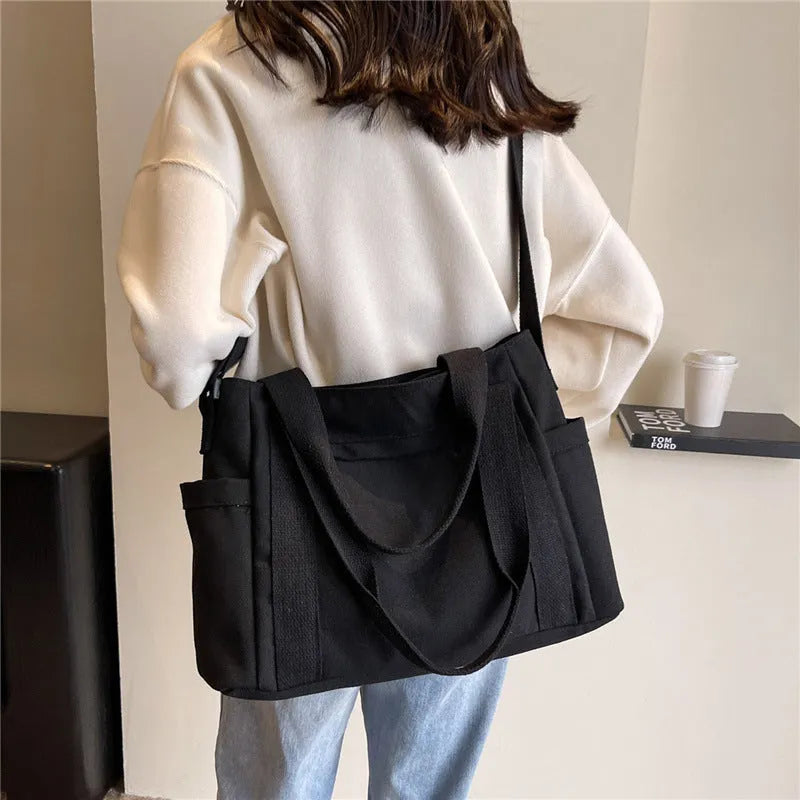 Large capacity polyester canvas shoulder bag in solid colour with sandwich pocket