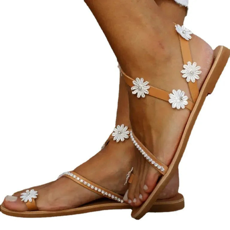 Brown women's Roman sandals with floral decoration on upper and flat rubber soles