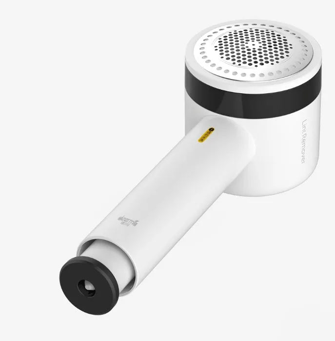 White rechargeable lint remover with three blades, hidden collection container, and ABS build on a plain background