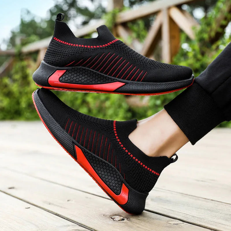 Men's black and white striped mesh sock shoes with Flyknit upper and lace-up front.