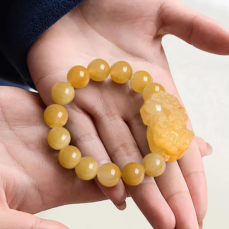 Hand-carved Jinsi Jade money bracelet with traditional coin pendant in golden-threaded stone