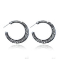 A pair of C-shaped alloy earrings with a vintage engraved pattern, shown in bronze colour.