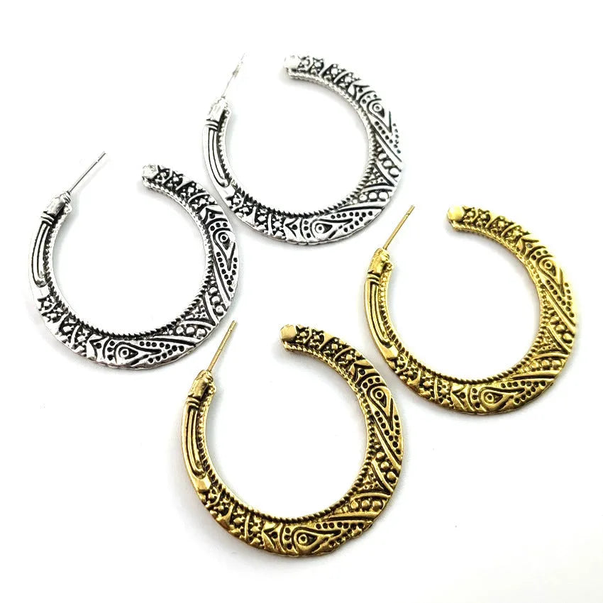 A pair of C-shaped alloy earrings with a vintage engraved pattern, shown in bronze colour.