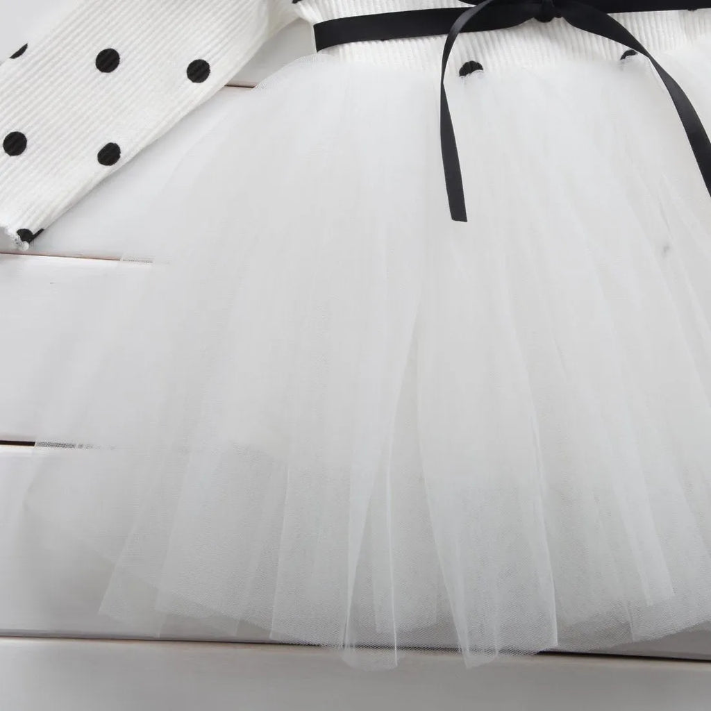 Baby girl in a long sleeve black tutu lace dress for a birthday party.