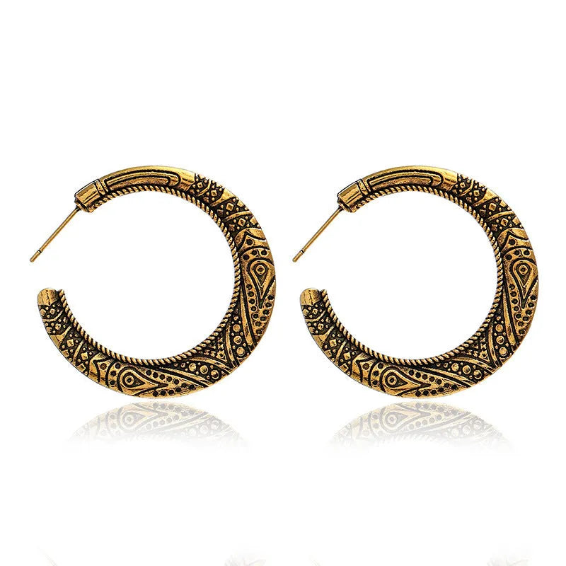 A pair of C-shaped alloy earrings with a vintage engraved pattern, shown in bronze colour.