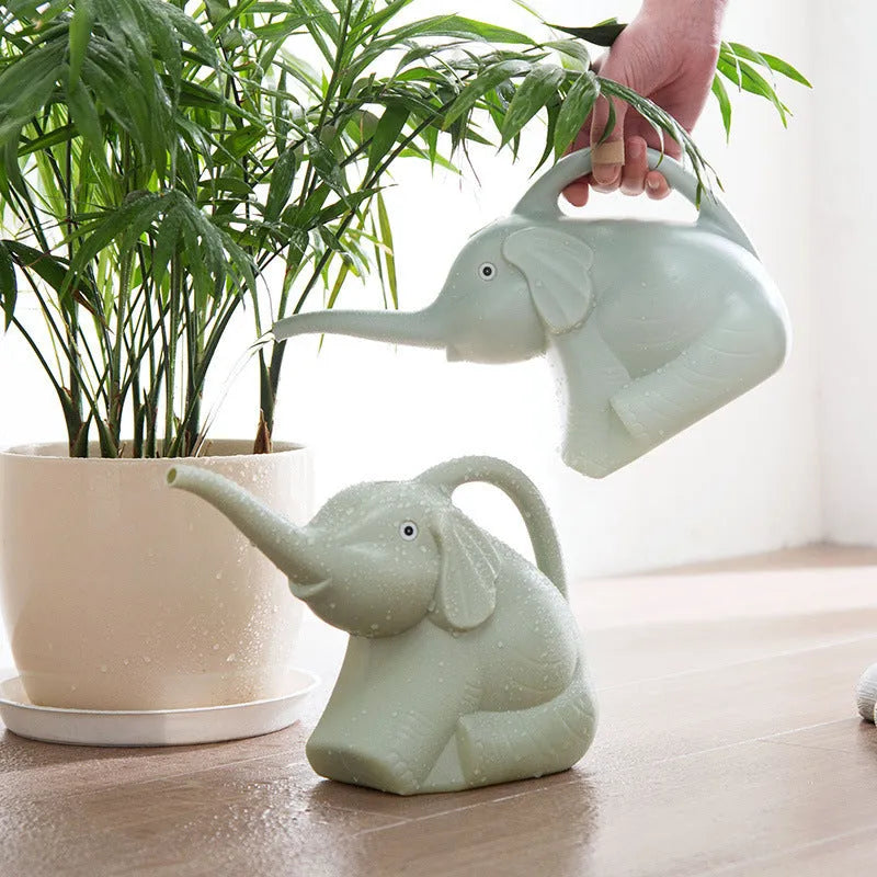 Pink elephant-shaped children's watering can with long nozzle and baby bottle handle.