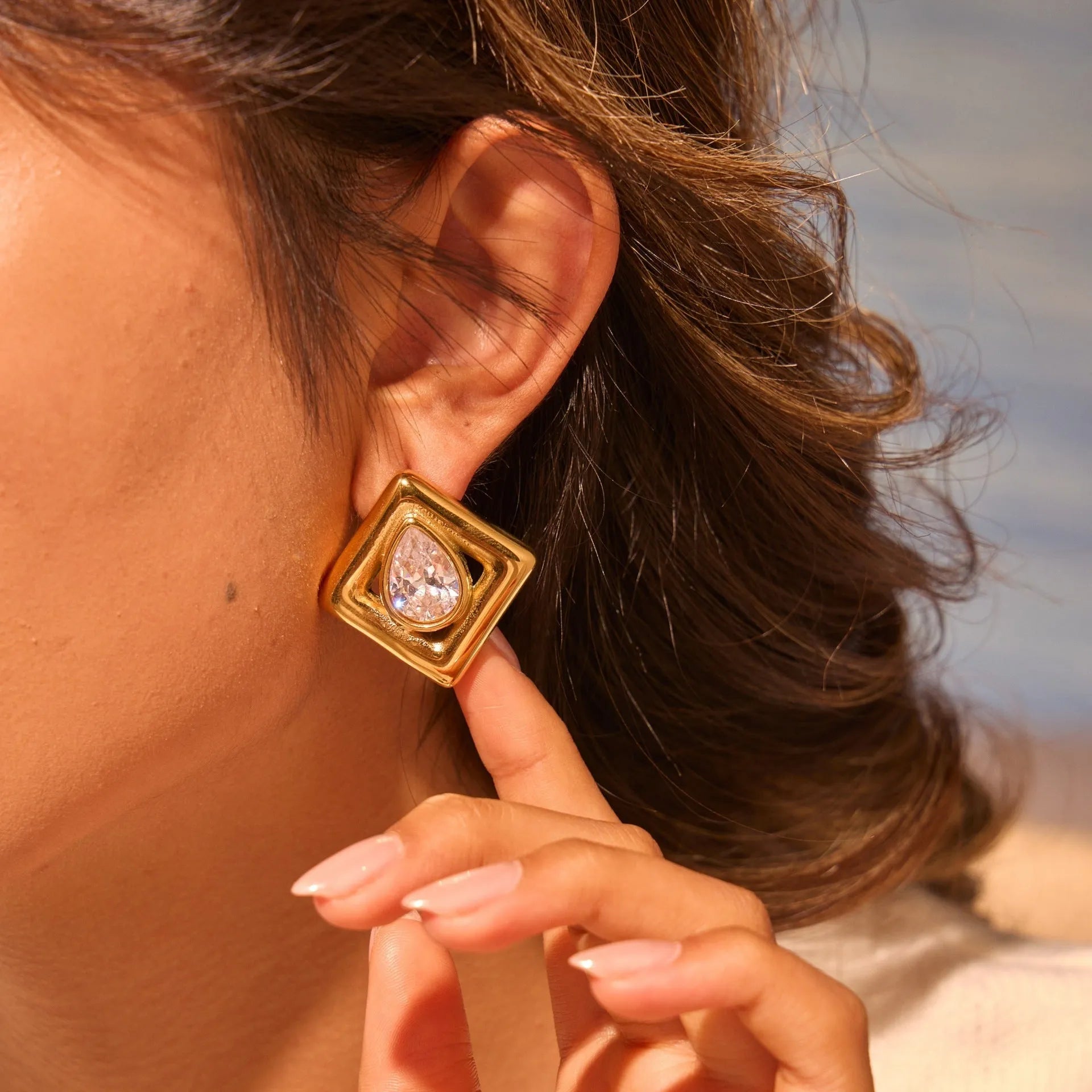 Geometric water drop shaped stud earrings with inlaid zircon stone and gold colour finish