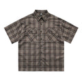 Men's black plaid shirt with embroidered letter detailing and short sleeves