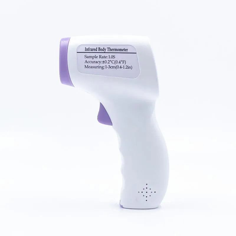 White digital thermometer for non-contact temperature measurement on a table.