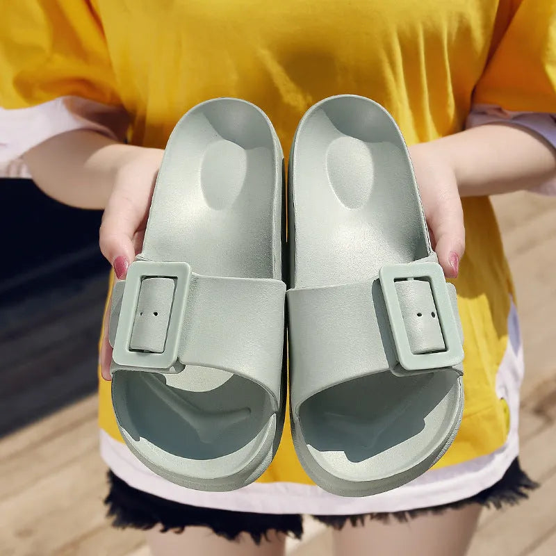 Women's grey blue EVA buckle slippers showing adjustable strap and soft sole.