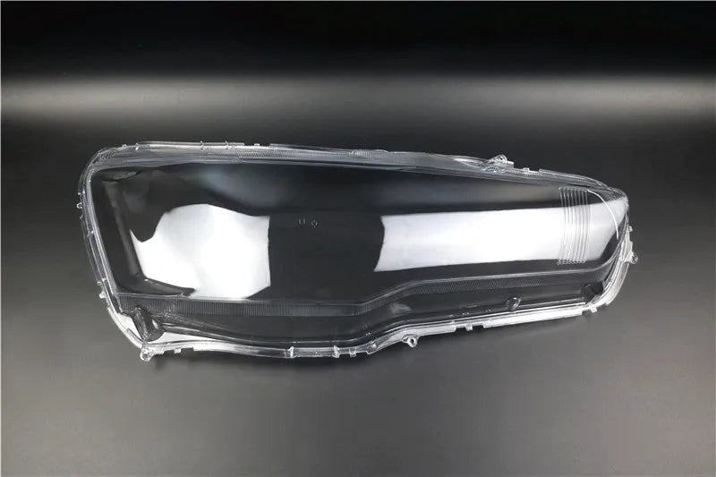 Transparent plastic headlight housing cover measuring 50mm by 30mm by 20mm