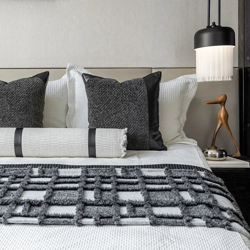 Grey and white plaid bed runner blanket with matching pillow on a 1.5m bed in a minimalist bedroom setting.