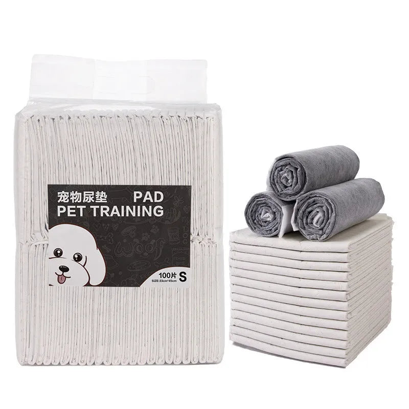 Pack of white pet urinal pads showing layered construction and multiple sizes for dogs and cats.