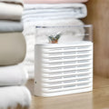 White recyclable cabinet dehumidifier box with transparent top showing orange silica gel beads