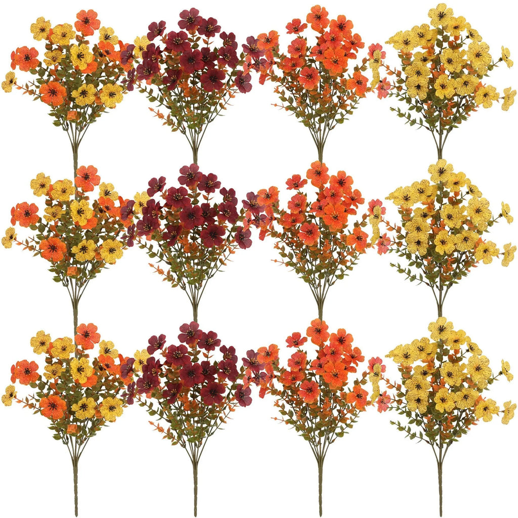 Artificial silk flower bouquet in autumn colours of red, yellow, and orange for wedding and home decoration