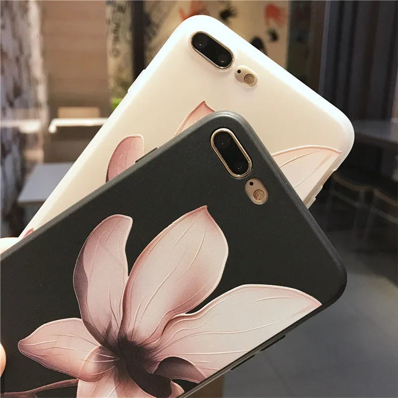 Slim black iPhone case with a single raised embossed flower design on the back.