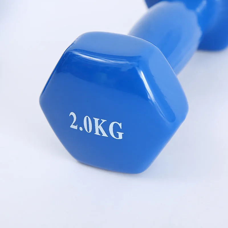 Brightly coloured plastic-coated fitness dumbbells in various weights on a floor.