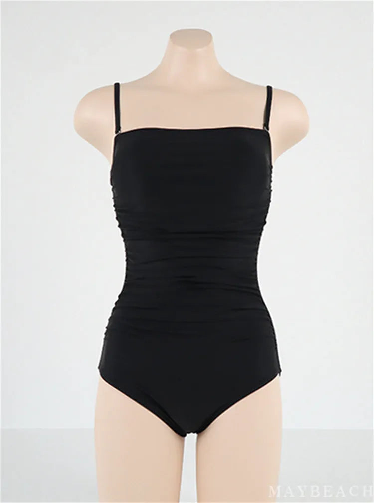 Blue sling style one-piece women's swimsuit with belly pleats and a slim fit design.