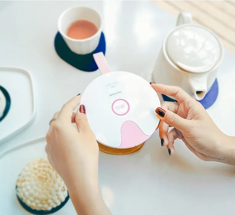 A slim, portable baby bottle sterilizer in blue or pink, showing USB port and compact design.