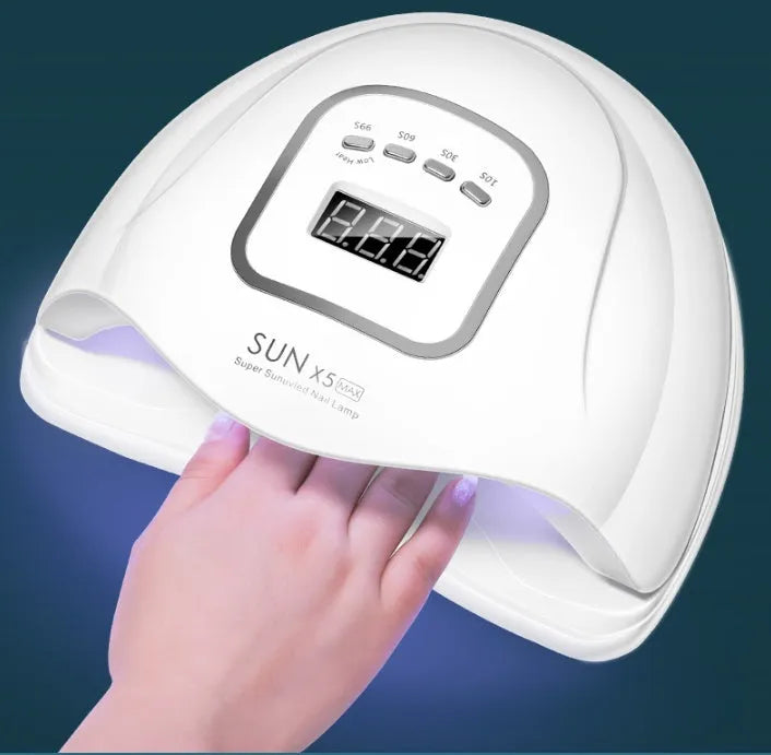 White nail polish quick-drying baking lamp dryer with dual UV and LED light sources on a clean surface.