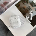 Hard white marble-pattern PC protective case fitted on an AirPods wireless earbud charging box.